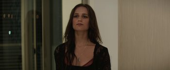 Movie still from “Son of a Gun” (2014), directed by Julius Avery – A woman with long dark brown hair wearing a black top; Close Up shot, Over the shoulder angle