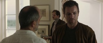 Movie still from “Son of a Gun” (2014), directed by Julius Avery – Two men are standing in front of each other; Medium shot, Over the shoulder angle