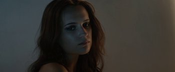 Movie still from “Son of a Gun” (2014), directed by Julius Avery – A beautiful woman with long brown wavy hair; Close Up shot, Low angle