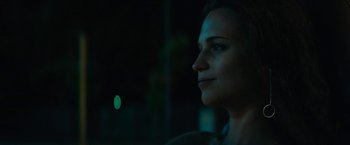 Movie still from “Son of a Gun” (2014), directed by Julius Avery – A woman's face in the dark; Close Up shot, Over the shoulder angle