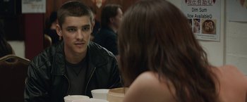 Movie still from “Son of a Gun” (2014), directed by Julius Avery – A man and a woman are sitting at a table; Close Up shot, Over the shoulder angle