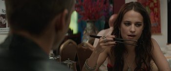 Movie still from “Son of a Gun” (2014), directed by Julius Avery – A woman holding a cell phone in her hand; Close Up shot, Over the shoulder angle