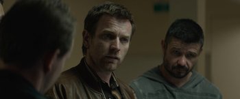 Movie still from “Son of a Gun” (2014), directed by Julius Avery – A person wearing a leather jacket; Close Up shot, Over the shoulder angle