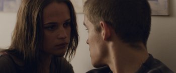 Movie still from “Son of a Gun” (2014), directed by Julius Avery – A man and a woman looking at one another; Close Up shot, Over the shoulder angle