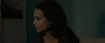 Movie still from “Son of a Gun” (2014), directed by Julius Avery – A person with long black hair; Close Up shot, Over the shoulder angle