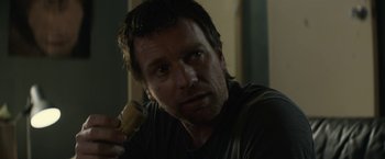 Movie still from “Son of a Gun” (2014), directed by Julius Avery – A person holding a remote control; Close Up shot, Over the shoulder angle