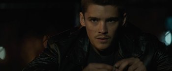 Movie still from “Son of a Gun” (2014), directed by Julius Avery – A person wearing a leather jacket; Close Up shot, Low angle