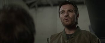 Movie still from “Son of a Gun” (2014), directed by Julius Avery – A person wearing a jacket; Close Up shot, Over the shoulder angle