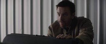 Movie still from “Son of a Gun” (2014), directed by Julius Avery – A man looking at a computer screen; Close Up shot, Over the shoulder angle