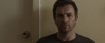 Movie still from “Son of a Gun” (2014), directed by Julius Avery – A person wearing a black t - shirt; Close Up shot, Low angle