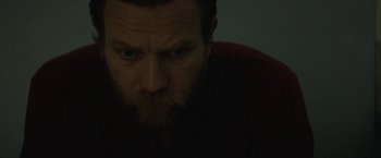 Movie still from “Son of a Gun” (2014), directed by Julius Avery – A person with a beard looking at the camera; Close Up shot, Over the shoulder angle