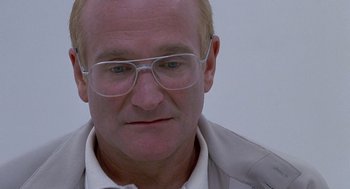 Movie still from “One Hour Photo” (2002), directed by Mark Romanek – A person wearing glasses and a jacket; Close Up shot, Over the shoulder angle