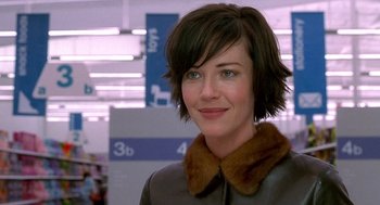 Movie still from “One Hour Photo” (2002), directed by Mark Romanek – A person with short hair wearing a jacket; Close Up shot, Over the shoulder angle