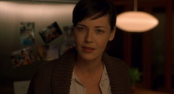 Movie still from “One Hour Photo” (2002), directed by Mark Romanek – A person with short hair; Close Up shot, Over the shoulder angle