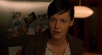 Movie still from “One Hour Photo” (2002), directed by Mark Romanek – A person wearing a sweater; Close Up shot, Over the shoulder angle