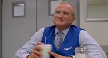Movie still from “One Hour Photo” (2002), directed by Mark Romanek – An older man sitting at a table holding a drink; Close Up shot, Low angle