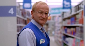 Movie still from “One Hour Photo” (2002), directed by Mark Romanek – A man wearing a blue vest and a tie; Close Up shot, Over the shoulder angle