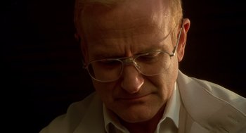 Movie still from “One Hour Photo” (2002), directed by Mark Romanek – An older man wearing glasses and a white dress shirt; Close Up shot, Low angle