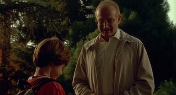 Movie still from “One Hour Photo” (2002), directed by Mark Romanek – An older man standing next to a young boy; Medium shot, Over the shoulder angle