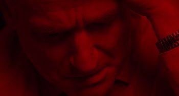 Movie still from “One Hour Photo” (2002), directed by Mark Romanek – A man with his eyes closed and his head tilted to the side; Extreme Close Up shot, Overhead angle