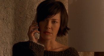 Movie still from “One Hour Photo” (2002), directed by Mark Romanek – A woman is talking on a cell phone; Close Up shot, High angle