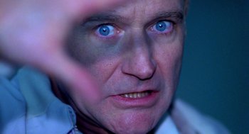 Movie still from “One Hour Photo” (2002), directed by Mark Romanek – A person with blue eyes; Extreme Close Up shot, Low angle