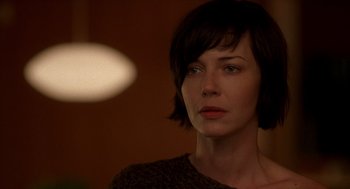 Movie still from “One Hour Photo” (2002), directed by Mark Romanek – A person with short hair; Close Up shot, Over the shoulder angle