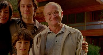 Movie still from “One Hour Photo” (2002), directed by Mark Romanek – Two men and a boy standing next to each other; Close Up shot, Low angle