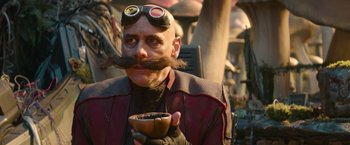 Movie still from “Sonic the Hedgehog 2” (2022), directed by Jeff Fowler – A bald man with a mustache holding a cup of coffee; Close Up shot, Over the shoulder angle