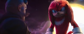 Movie still from “Sonic the Hedgehog 2” (2022), directed by Jeff Fowler – A person standing next to knuckles the echidna; Close Up shot, Over the shoulder angle