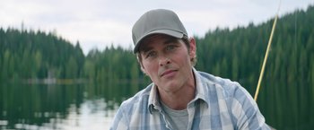 Movie still from “Sonic the Hedgehog 2” (2022), directed by Jeff Fowler – A person wearing a hat near a body of water; Close Up shot, Over the shoulder angle