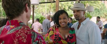 Movie still from “Sonic the Hedgehog 2” (2022), directed by Jeff Fowler – A woman holding a drink and smiling; Medium shot, Over the shoulder angle