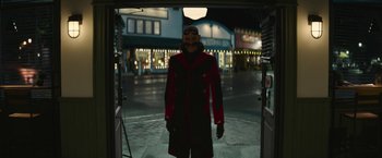 Movie still from “Sonic the Hedgehog 2” (2022), directed by Jeff Fowler – A person wearing a red and black outfit and a mask; Wide shot, Low angle