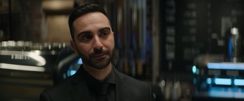 Movie still from “Sonic the Hedgehog 2” (2022), directed by Jeff Fowler – A person wearing a suit and tie; Close Up shot, Over the shoulder angle