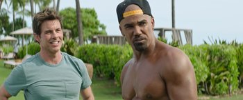 Movie still from “Sonic the Hedgehog 2” (2022), directed by Jeff Fowler – A man with a hat on and no shirt on; Medium shot, Over the shoulder angle