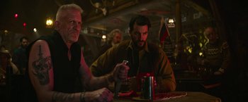 Movie still from “Sonic the Hedgehog 2” (2022), directed by Jeff Fowler – A man sitting at a table holding a knife; Medium shot, Over the shoulder angle