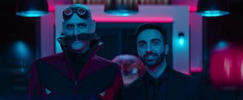 Movie still from “Sonic the Hedgehog 2” (2022), directed by Jeff Fowler – Two men are posing for a picture together; Medium shot, Over the shoulder angle