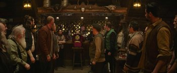 Movie still from “Sonic the Hedgehog 2” (2022), directed by Jeff Fowler – A group of men standing around a bar; Wide shot, Over the shoulder angle