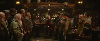 Movie still from “Sonic the Hedgehog 2” (2022), directed by Jeff Fowler – A group of people standing around a bar; Wide shot, Over the shoulder angle