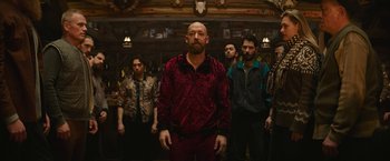 Movie still from “Sonic the Hedgehog 2” (2022), directed by Jeff Fowler – A group of men standing in front of a bar; Medium shot, Low angle