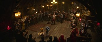 Movie still from “Sonic the Hedgehog 2” (2022), directed by Jeff Fowler – A group of people in a room with a crowd watching; Wide shot, High angle