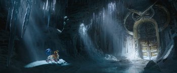 Movie still from “Sonic the Hedgehog 2” (2022), directed by Jeff Fowler – A person sitting on a rock in front of a waterfall; Extreme Wide shot, High angle