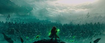 Movie still from “Sonic the Hedgehog 2” (2022), directed by Jeff Fowler – An image of a man standing in front of a mountain; Wide shot, Low angle