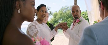 Movie still from “Sonic the Hedgehog 2” (2022), directed by Jeff Fowler – A man and a woman holding hands while standing next to each other on a beach; Medium shot, Over the shoulder angle