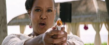Movie still from “Sonic the Hedgehog 2” (2022), directed by Jeff Fowler – A woman is holding a toy gun with her mouth open; Close Up shot, Low angle