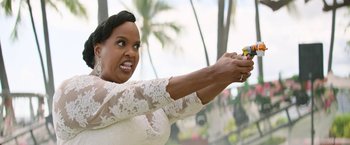 Movie still from “Sonic the Hedgehog 2” (2022), directed by Jeff Fowler – A woman in a white dress holding a yellow object; Close Up shot, Over the shoulder angle