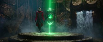 Movie still from “Sonic the Hedgehog 2” (2022), directed by Jeff Fowler – A man standing in front of a green light; Wide shot, Over the shoulder angle