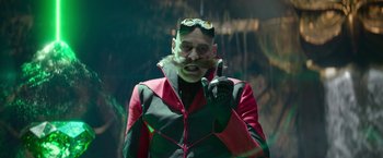 Movie still from “Sonic the Hedgehog 2” (2022), directed by Jeff Fowler – A man with a beard and mustache wearing goggles and a red and black jacket; Medium shot, Over the shoulder angle
