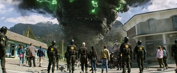 Movie still from “Sonic the Hedgehog 2” (2022), directed by Jeff Fowler – A group of people walking down a street near a black cloud of smoke; Wide shot, Low angle