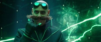 Movie still from “Sonic the Hedgehog 2” (2022), directed by Jeff Fowler – A man with a beard and mustache wearing goggles and a jacket; Close Up shot, Over the shoulder angle